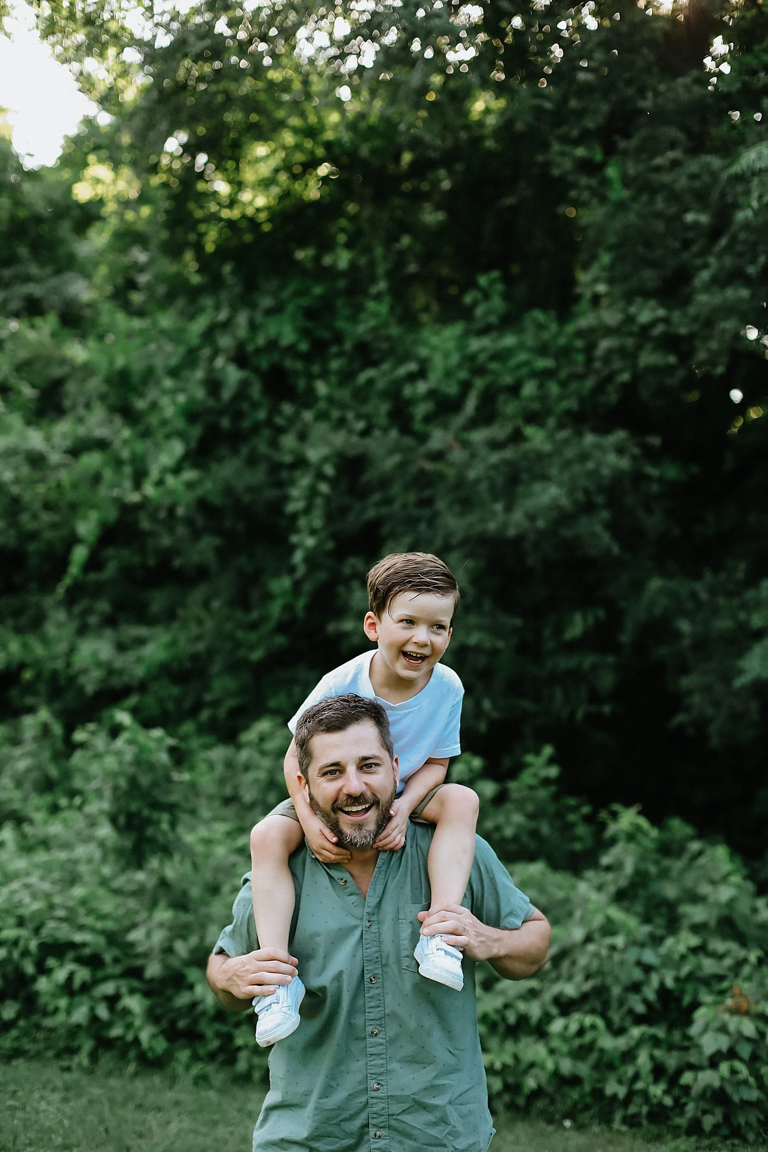  toddler sits on dads shoulders during golden hour by Round Rock family photographer 