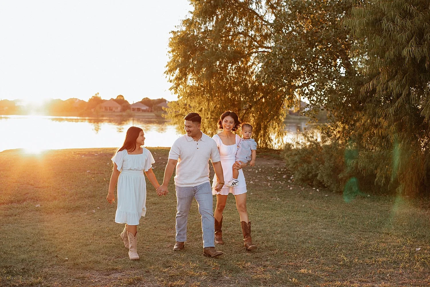  parents walk with two children in golden hour by Round Rock family photographer 