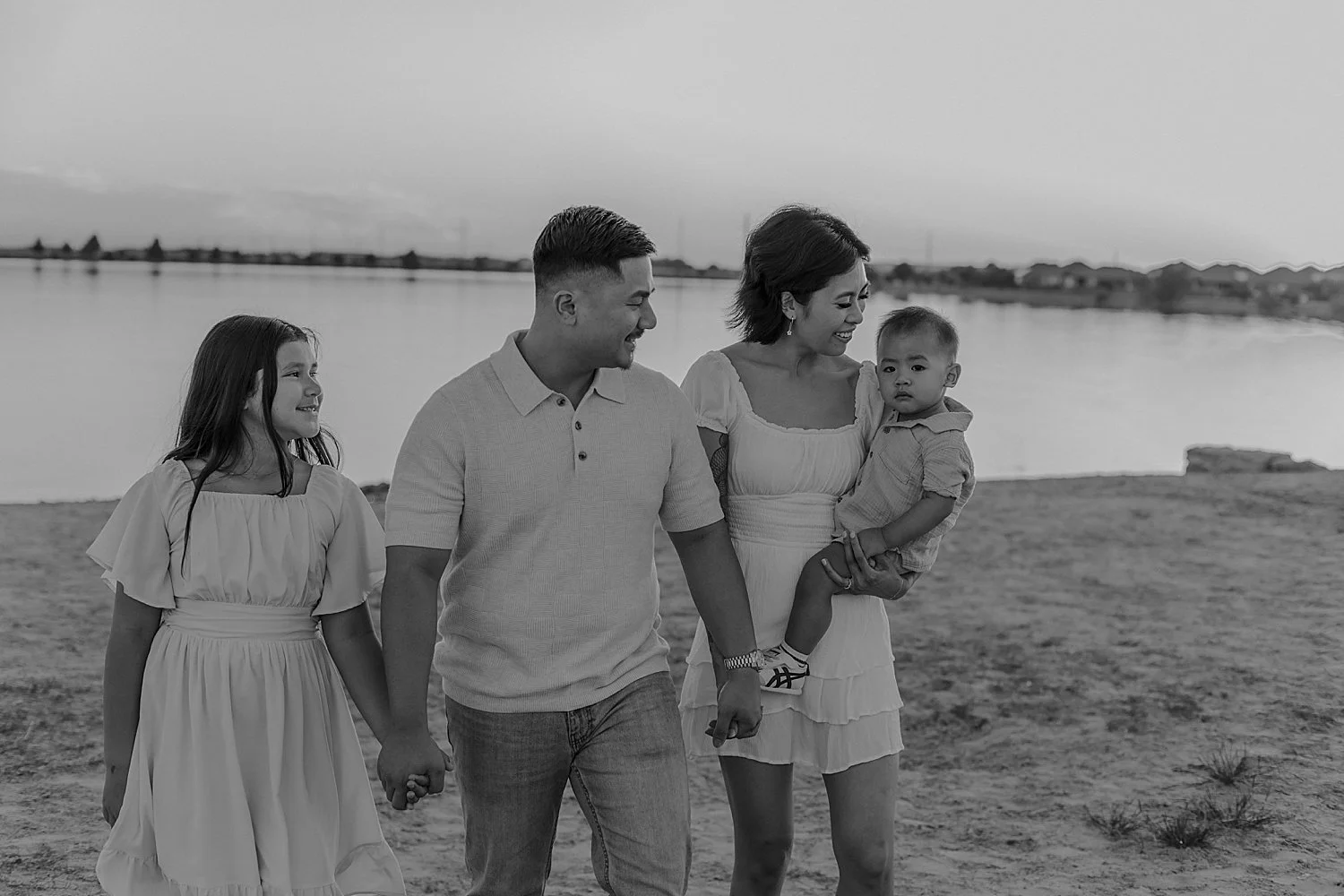  family of four walks across beach area for photo shoot at Lake Pflugerville 