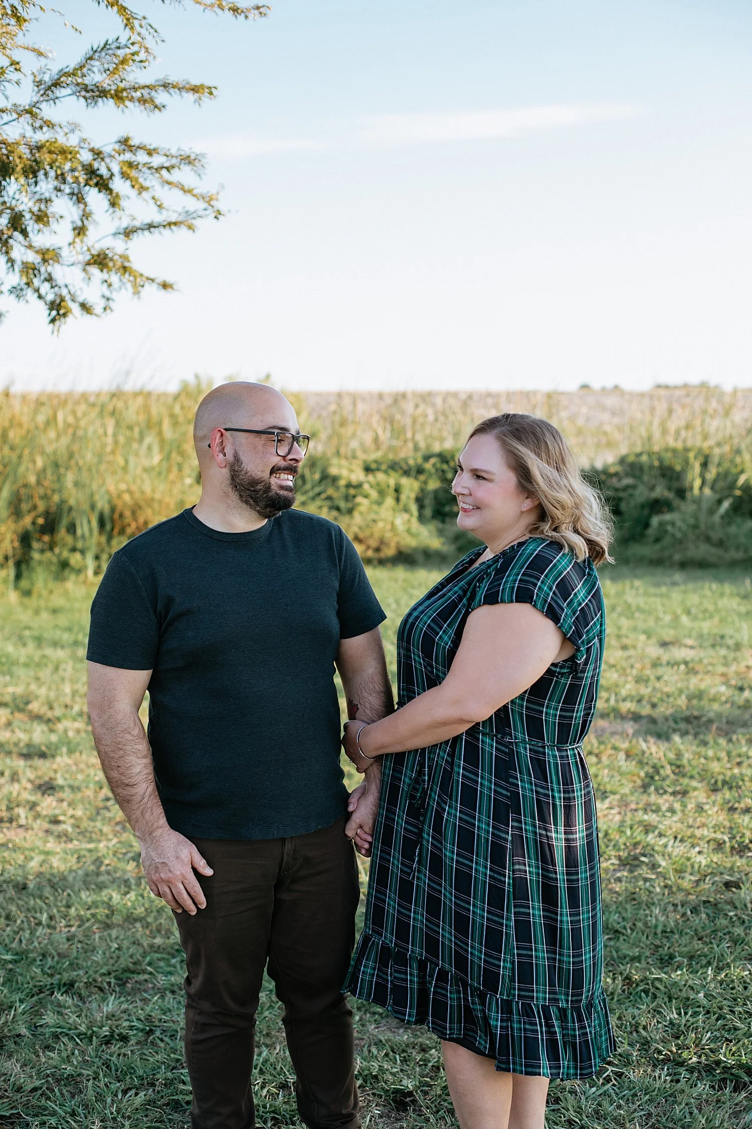  woman and man stand in front of field by Jessie Shaw Photo 