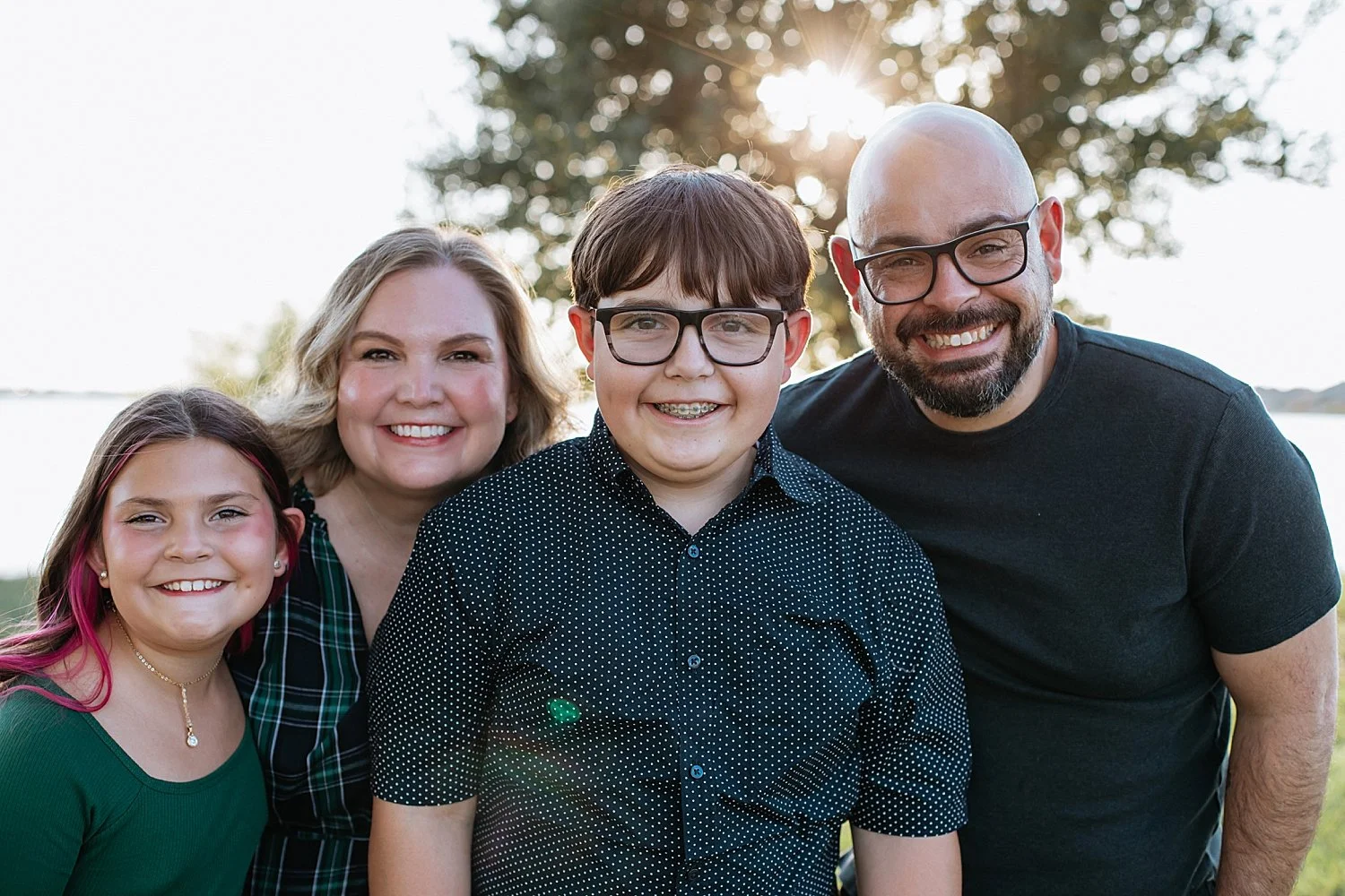  family of four lean in together smiling by Jessie Shaw Photo 