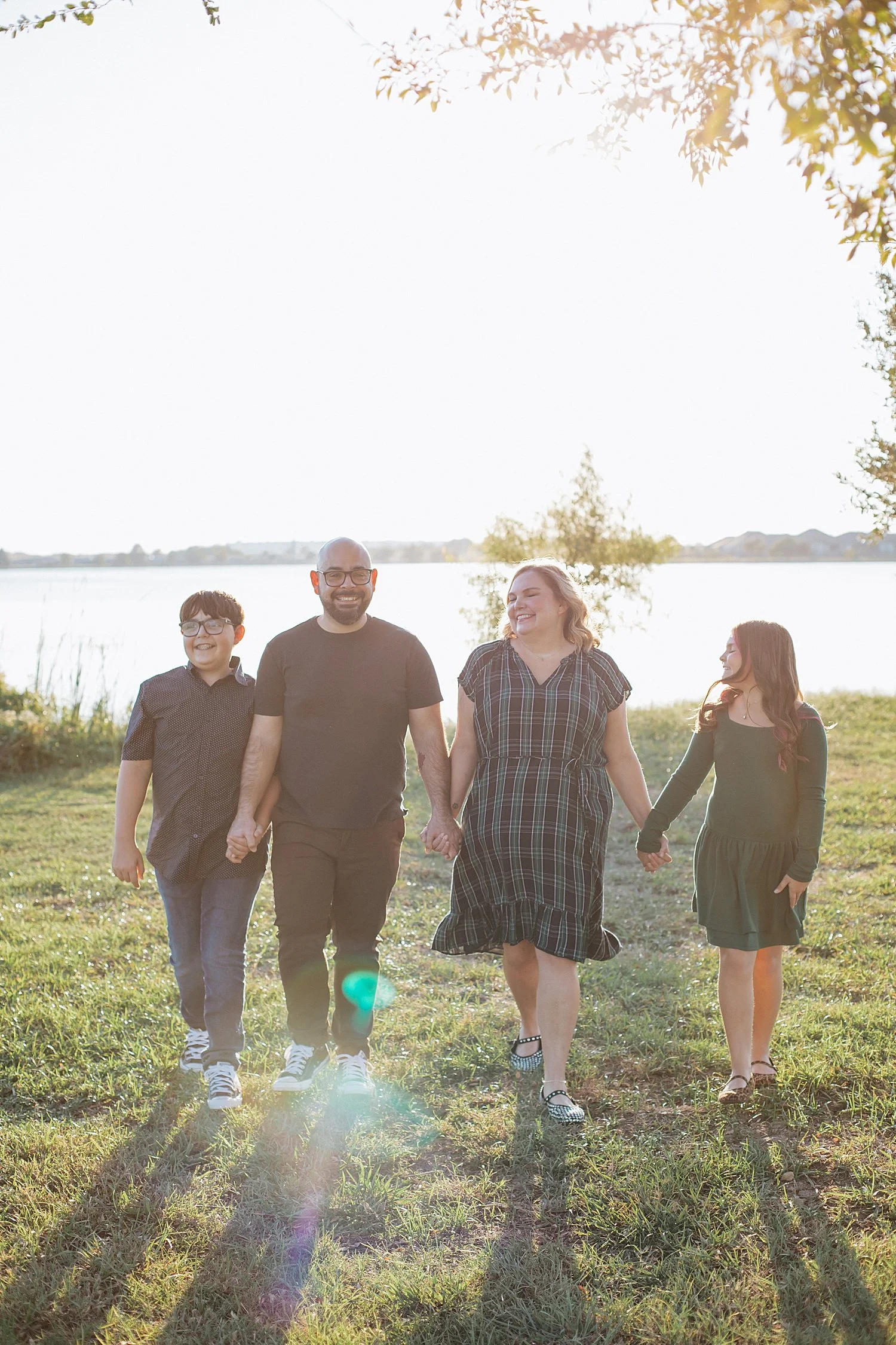  family of four walk in light flares for photos at Lake Pflugerville 