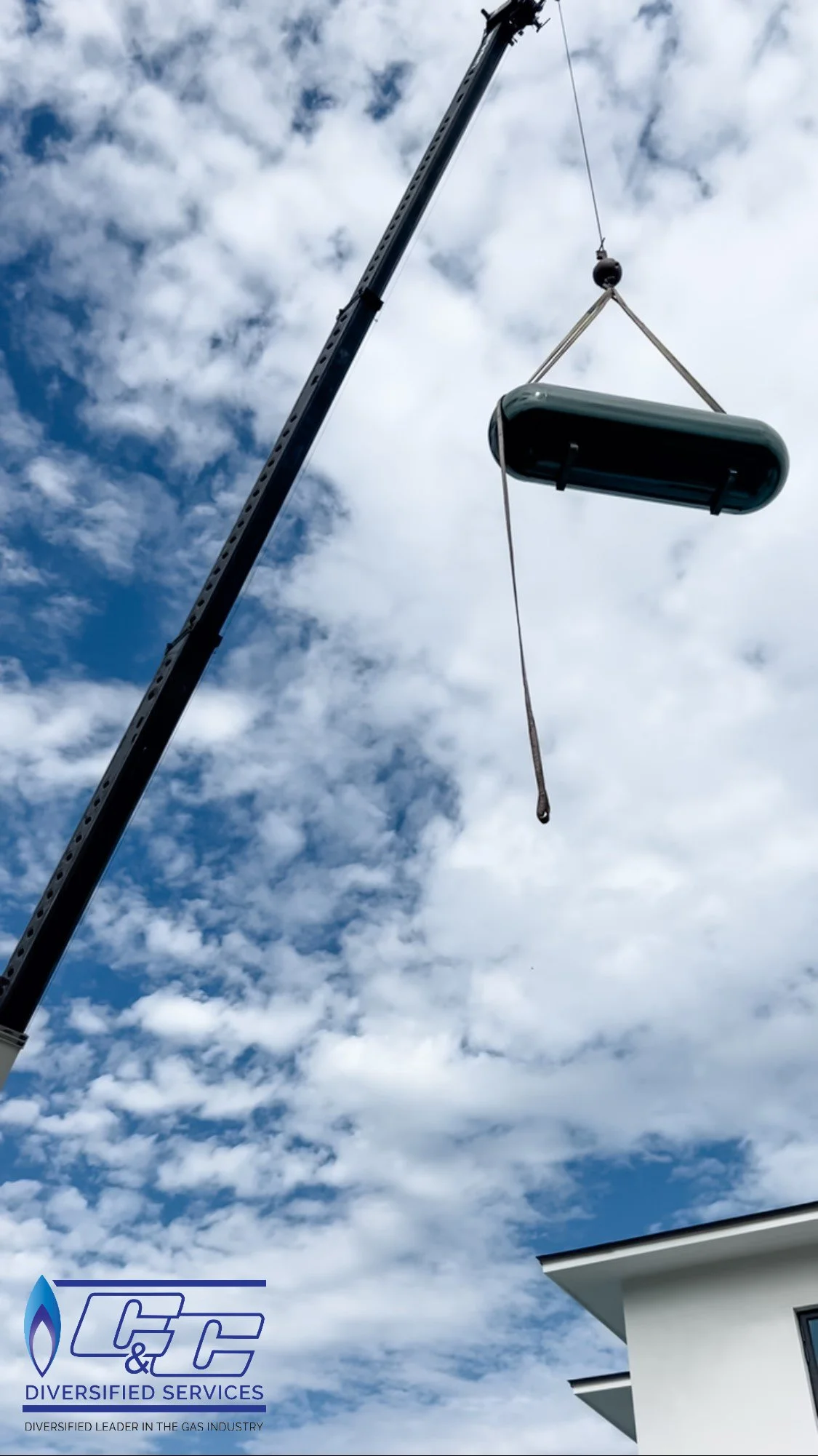 Using a crane to fly a 500-gallon underground LP tank over luxurious new construction in Jupiter.