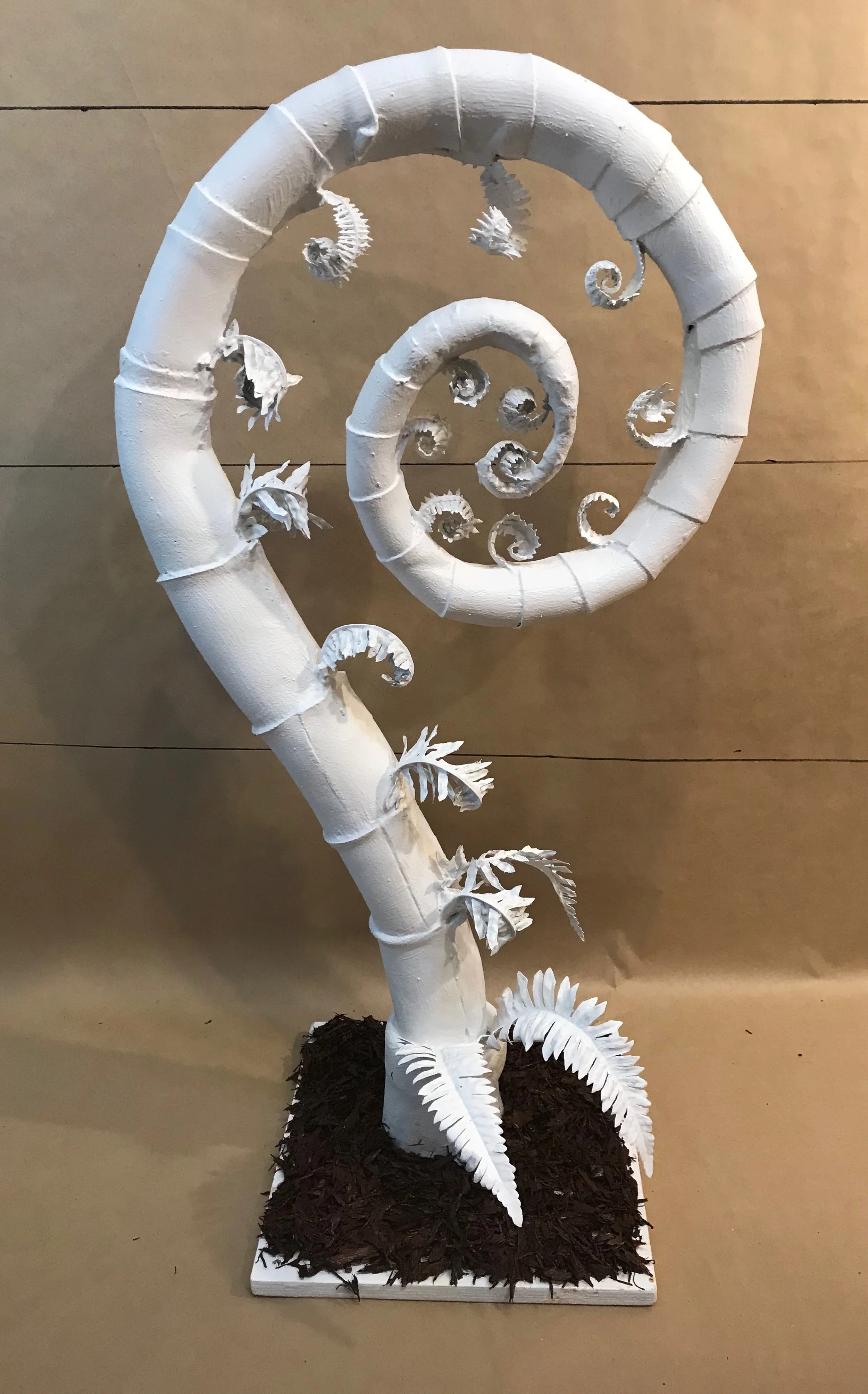 Between 2'-5' tall, upholstery foam, faux leaves, painted rubber, white top coat, attached to wooden base with rubber mulch 