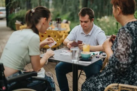 260578207-people-with-disabilities-enjoying-a-fun-card-game-outdoors.jpg
