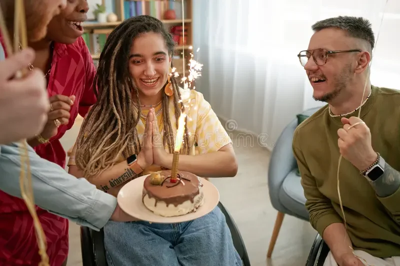 young-caucasian-woman-disability-celebrating-birthday-friends-indoors-multiethnic-group-young-adults-disability-385013814.webp
