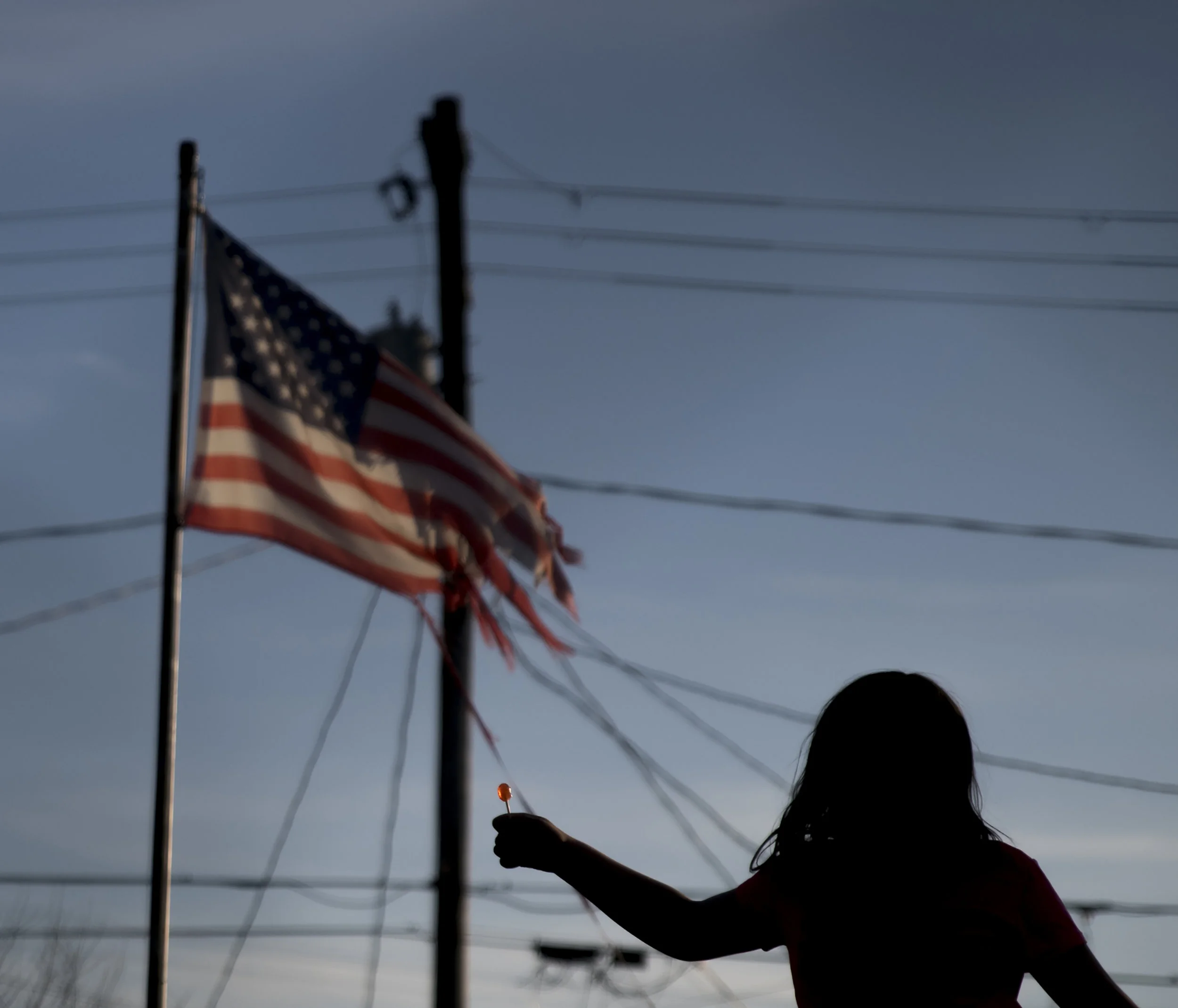 Third grader Lauren Shumway holds up a lollipop while jumping on her trampoline outside of her Nelsonville, Ohio home.