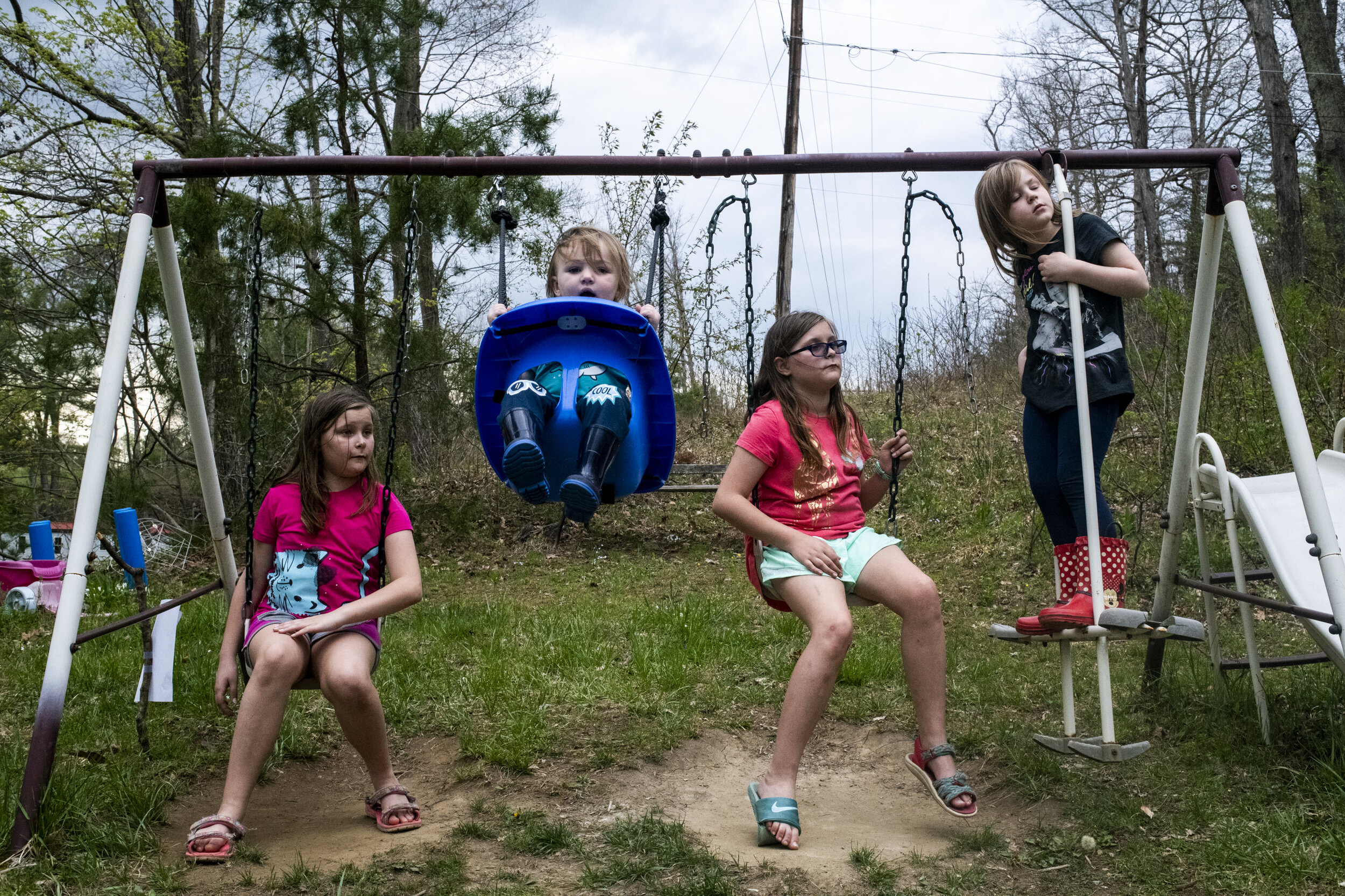  Rylie, Dominic, Ella and Izzy Cress play on the swingset in their front lawn in New Marshfield, Ohio in April 2019. Rylie and Ella are twin sisters and live on the same property as their cousins, Dominic and Izzy.  