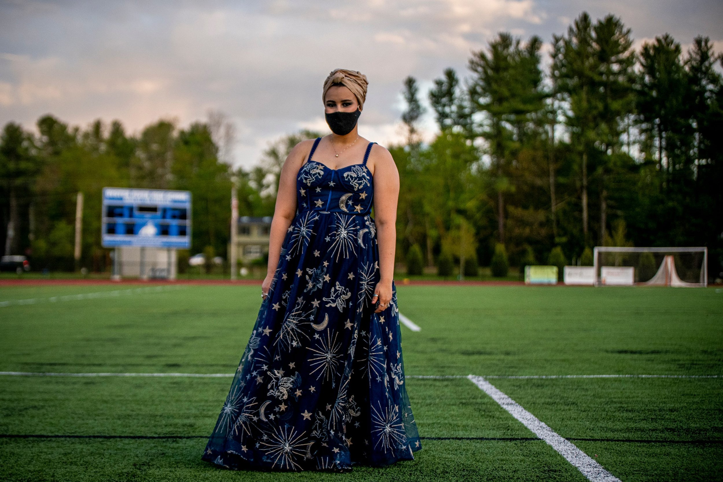  Oyster River High School student Anna Blezard, 18, poses during senior prom in Durham, New Hampshire on May 12, 2021. Oyster River High School juniors and seniors gathered outside, on the school's turf field, to celebrate what was  called a Mask-era
