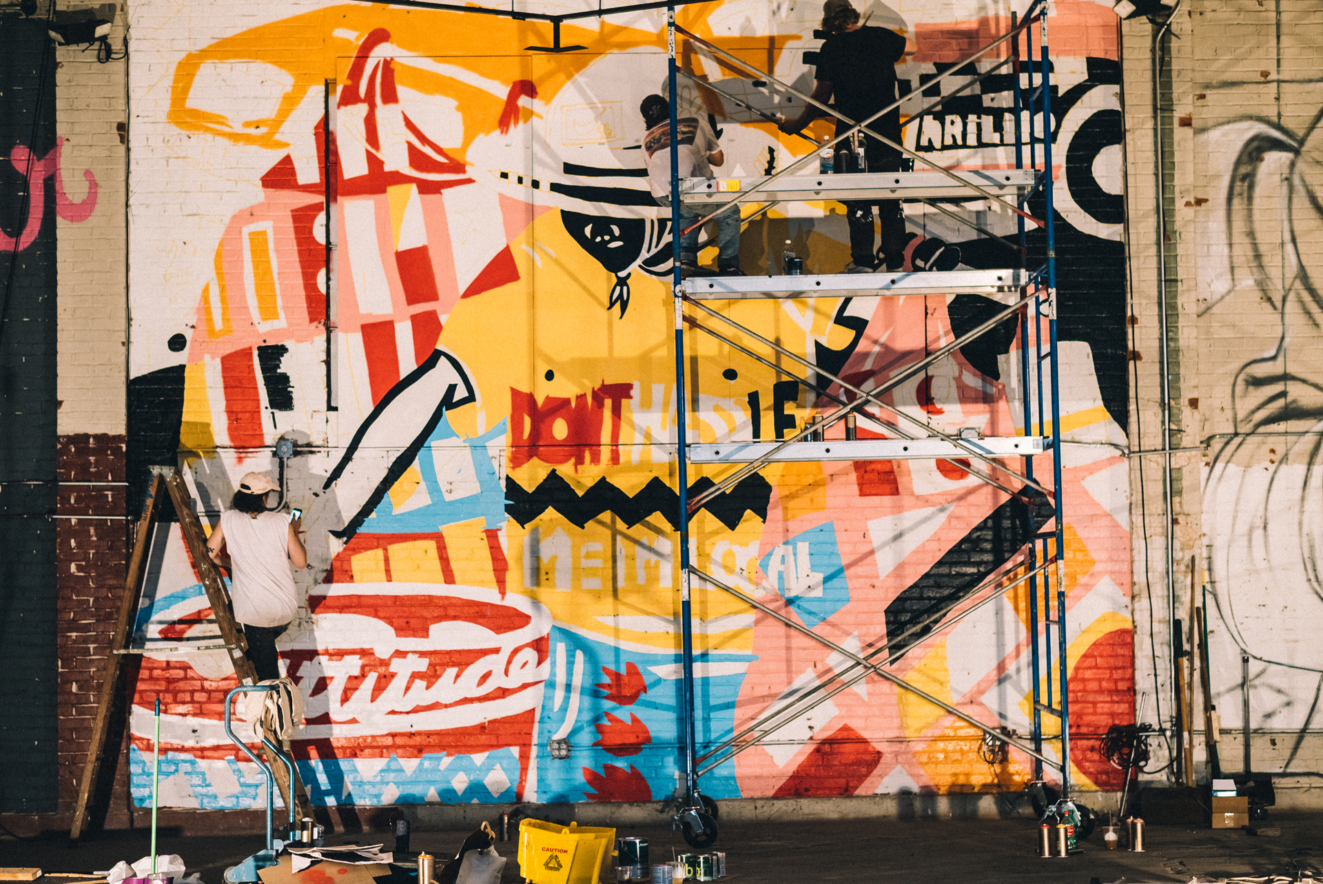 Adam Lucas working on “Don’t Hassle Me” mural, Market Surplus, June 2017