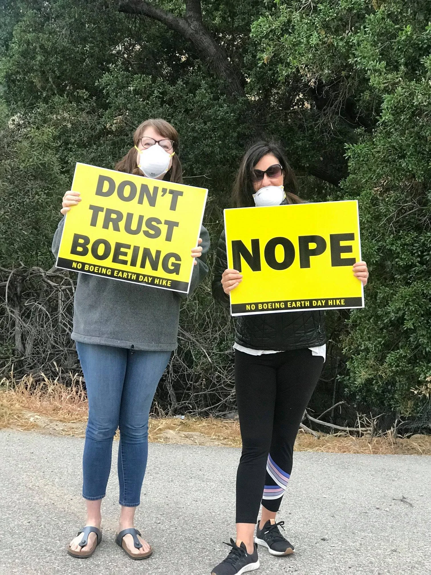 Ladies hold signs "Don't trust Boeing"