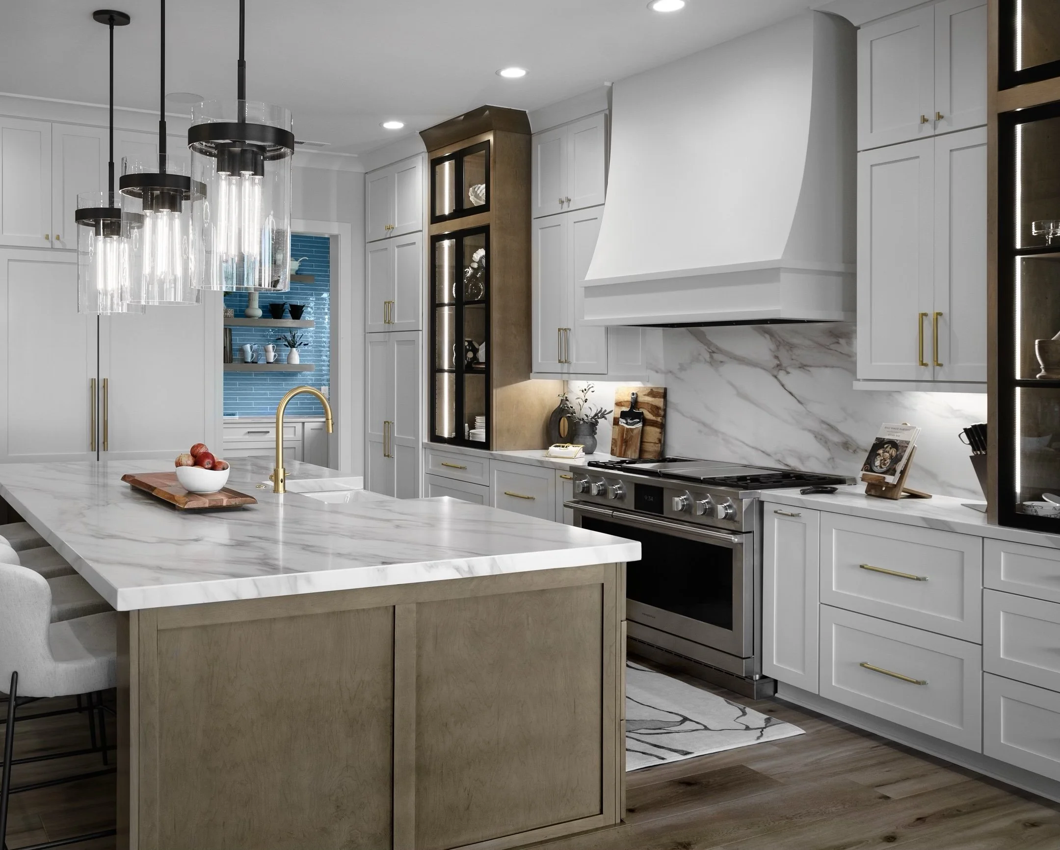  Modern kitchen interior with marble countertops, sleek black and gold pendant lights, white cabinetry, and stainless steel appliances. Features include a large island with seating, a blue-tiled backsplash, and elegant lighting.&nbsp; 