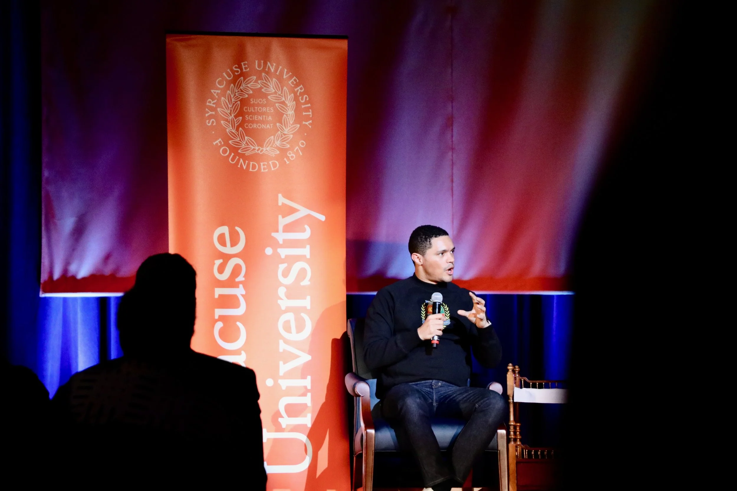 Trevor Noah takes the stage at the Carrier Dome in Syracuse University. The comedian, author, and television host was this year’s MLK dinner speaker. Photo by Saniya More .