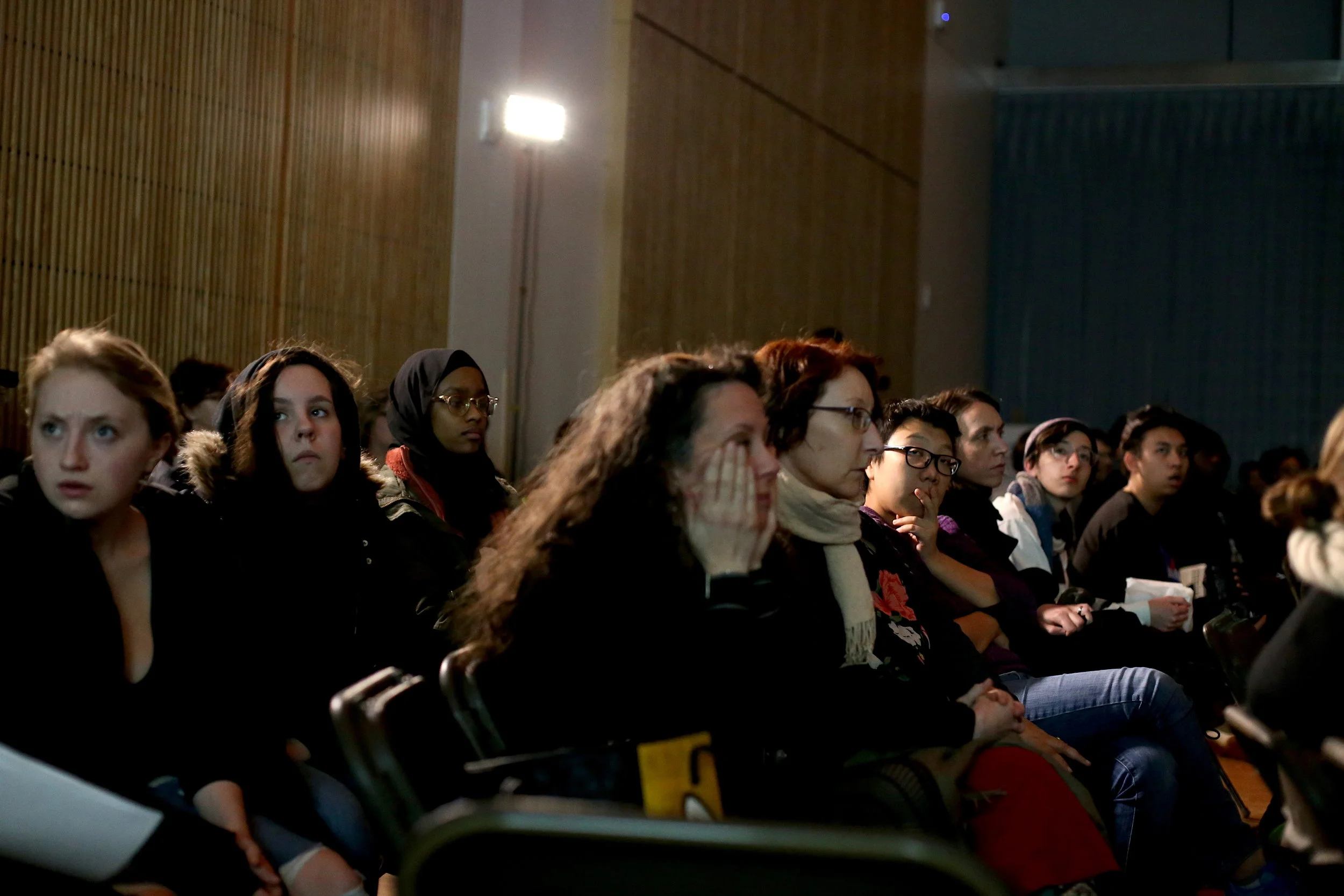 Audience members react to a short film series by an artist on one of the panels at Thursday’s symposium on race and justice. Photo by Jiaman (Maggie) Peng.