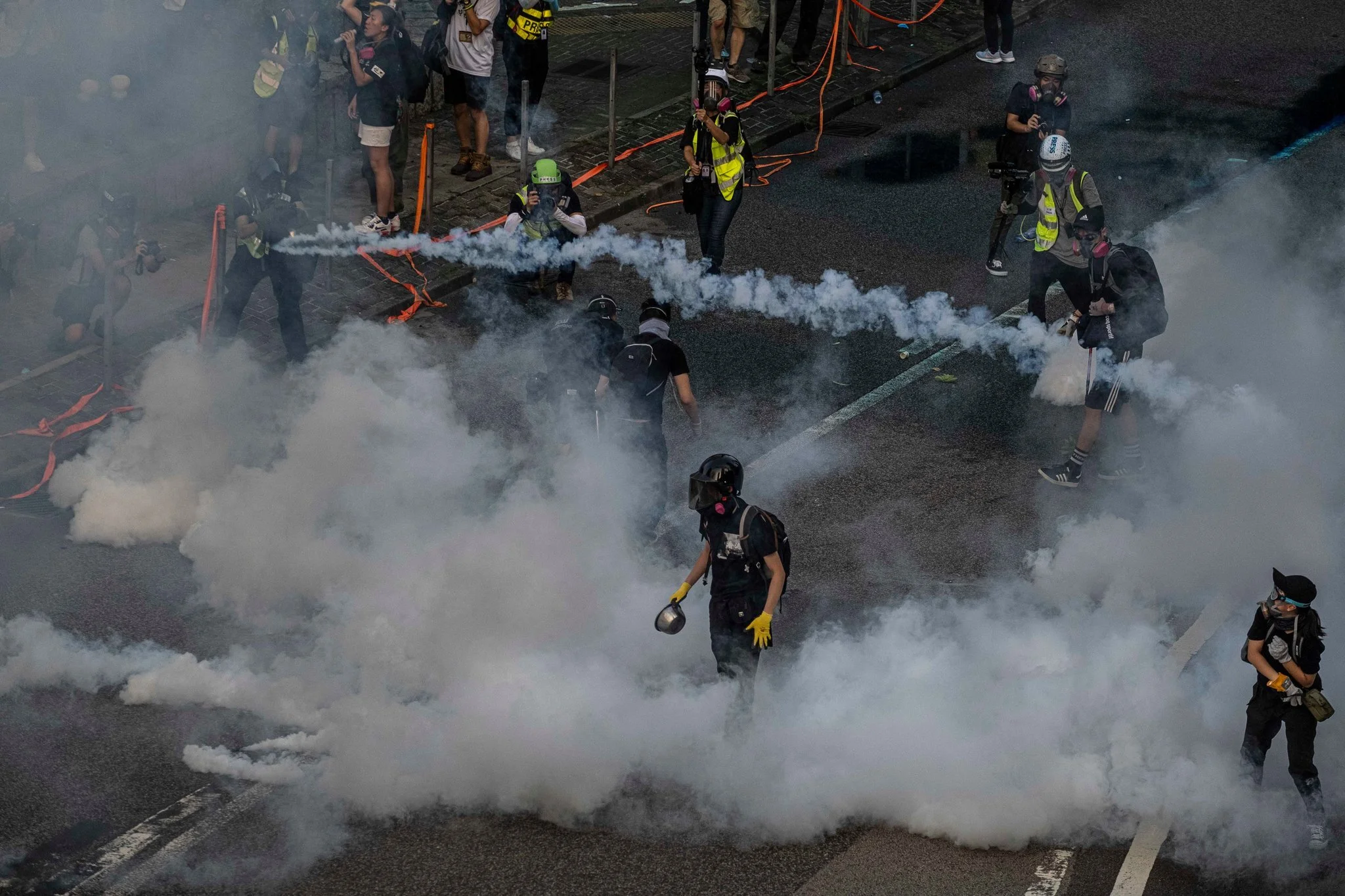 The masked protesters in Hong Kong hurled gasoline bombs at governmental buildings. Photo courtesy: Lam Yik Fei | The New York Times