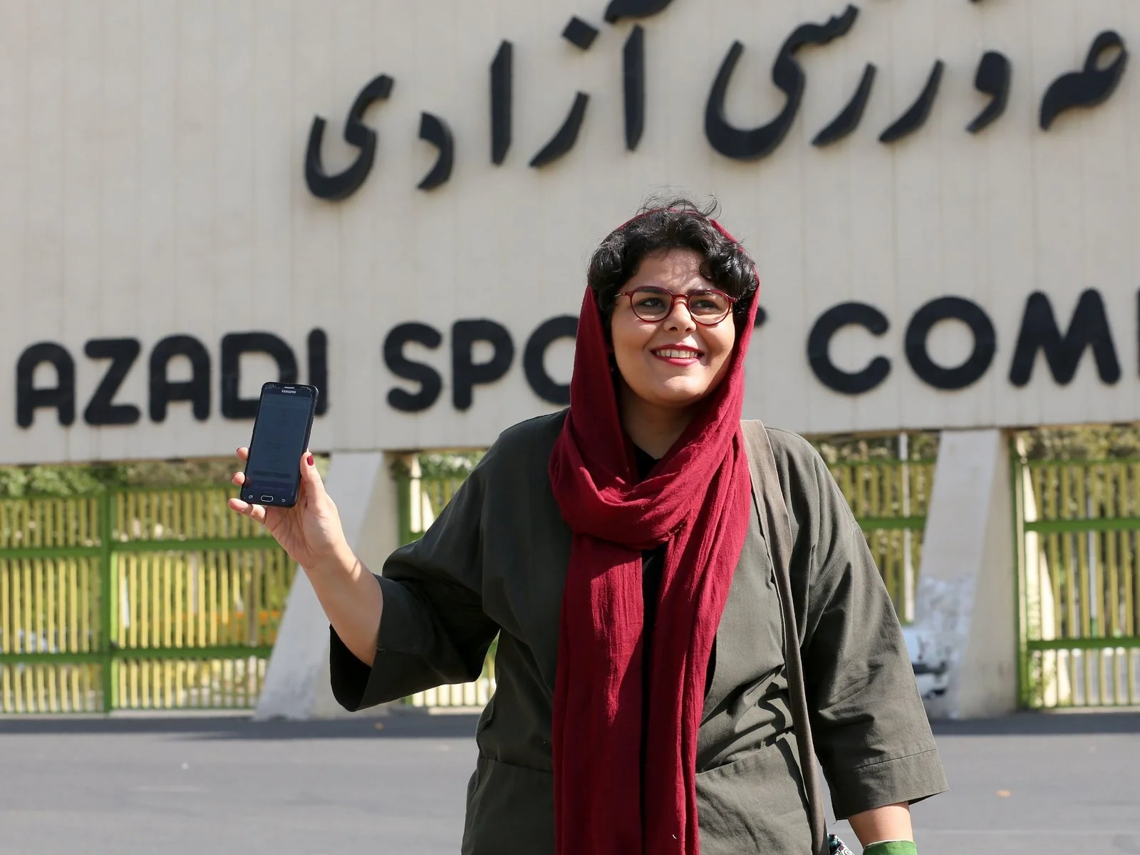 Raha Purbakhsh, a sports reporter in Iran, shows her ticket to a World Cup qualifier in front of Azadi Stadium in Tehran Tuesday. Atta Kenare | Getty Images