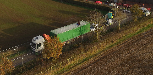 An activist surfs a lorry in Kirby Misperton. Photo courtesy of Yorkshire's Fracking Frontline
