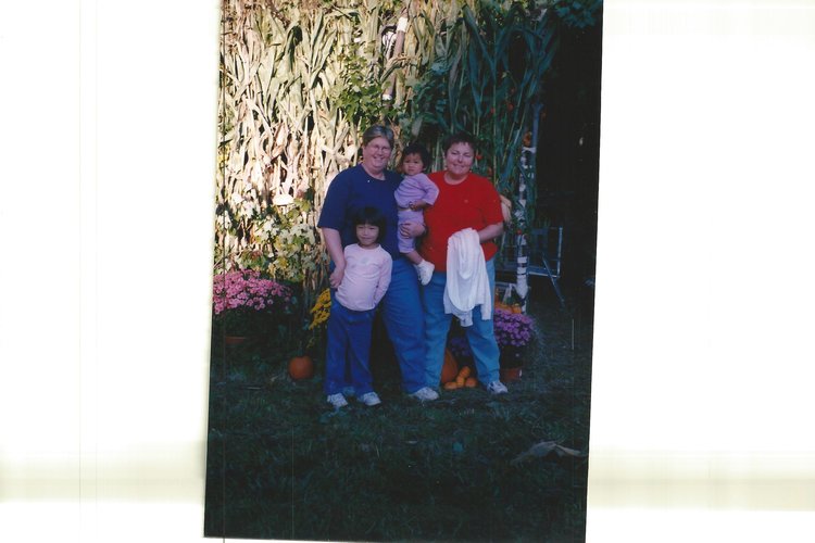 Casey Lu Simon-Plumb and family in front of a Sukkah (a traditional Jewish Structure constructed during Sukkot). 