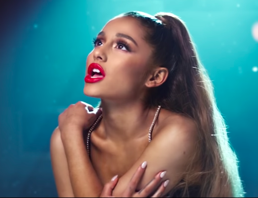 Grande hugging herself and looking up in the “breathin" music video