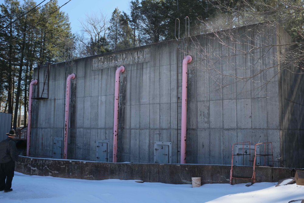  This building, the Cooling Tower,  is where water is chilled to an appropriate temperature before being pumped up the mountain to a snow gun. 
