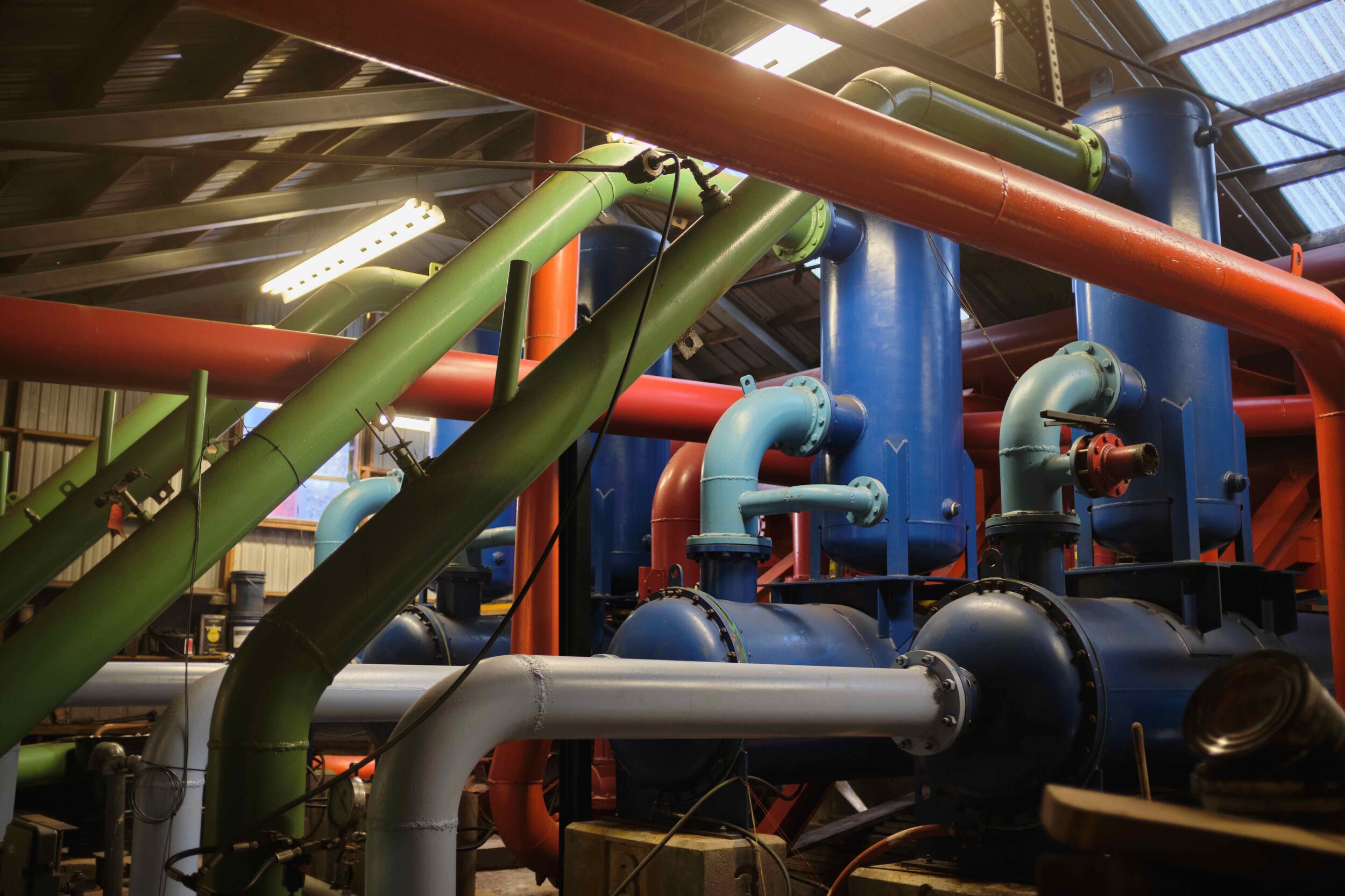  This menagerie of colorful pipes is all that keeps the hot air coming out of Hunter’s compressors from undermining the whole snowmaking operation. Large chambers take compressed air and cool it using vortices and heat exchangers. 