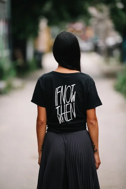 Motivational 'If Not Now, Then When' t-shirt on a booking page