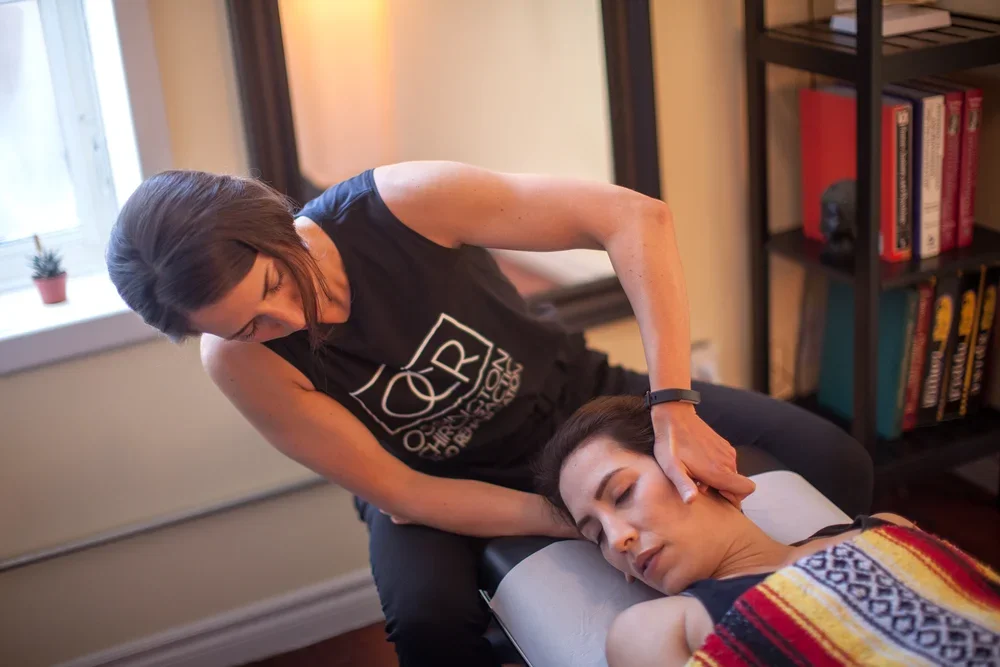 Chiropractor performing a neck adjustment on a patient.