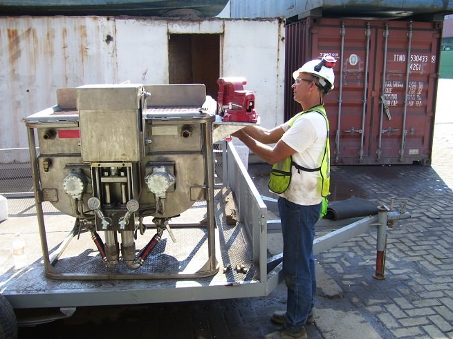 Substructure employee doing maintenance work on patented epoxy pump