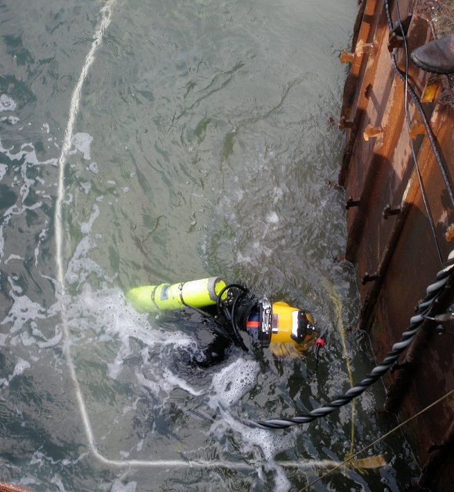 Commercial diver hydroblasting surface prior to placeing steel