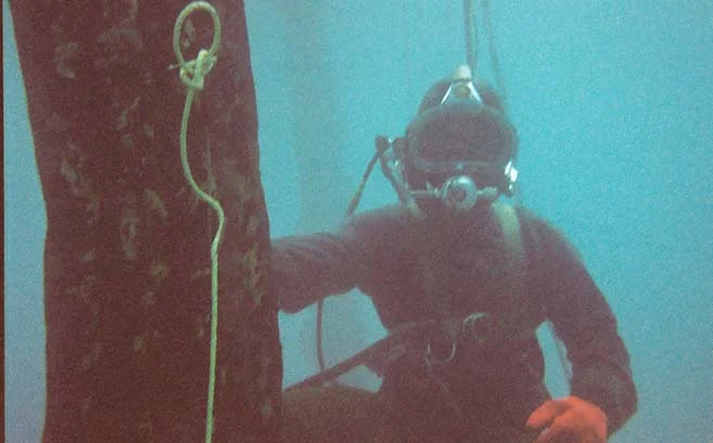 Surface-supplied commercial diver underwater. 