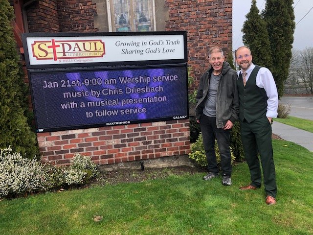 January 21, 2024 - Guest Artist Chris Driesbach and Pastor Hopper in front of the St. Paul sign.