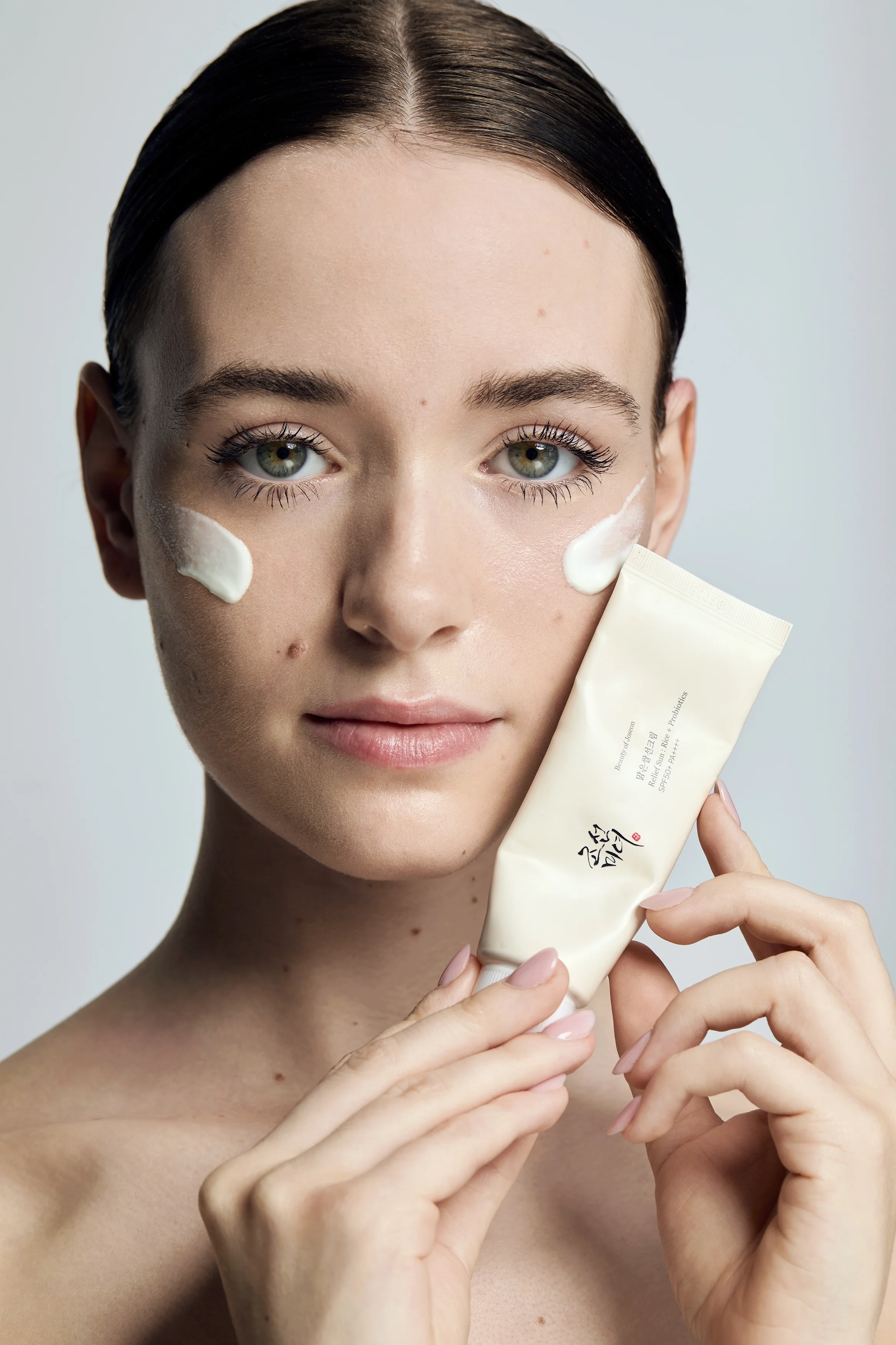  beauty shot of a model with face moisturiser tube,  skincare photoshoot, beauty photography, skincare photography, Egle Vasi, beauty photographer, beauty photographer London, beauty photographer Bristol 