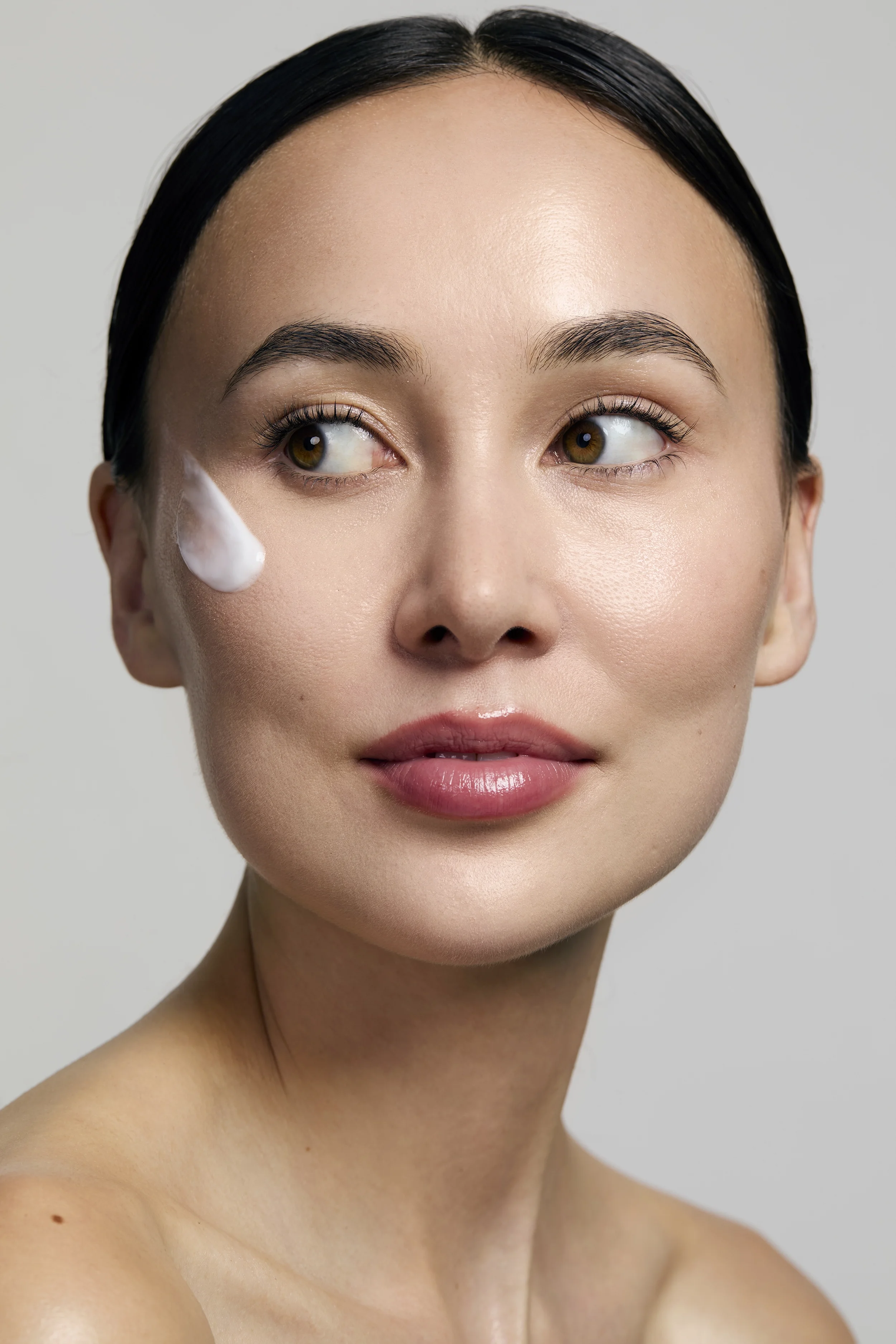  Korean model with moisturiser swab on the cheek skincare photoshoot, beauty photography, skincare photography, egle vasi, beauty photographer, beauty photographer london, beauty photographer, bristol 