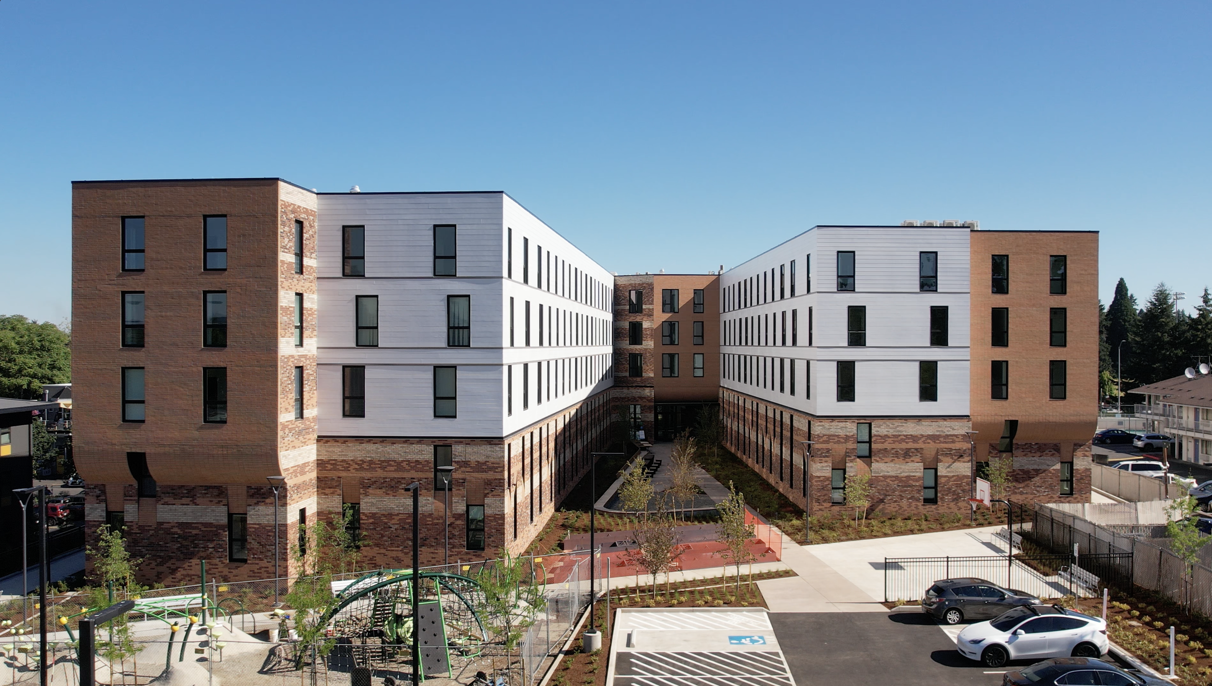 Hazel Ying Lee Apartments, a four story U-shaped brick and white apartment building.