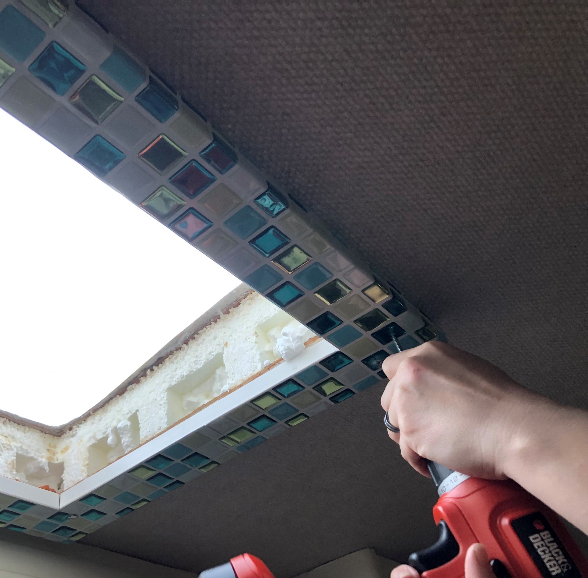 Attaching the frame to the ceiling - we used self-drilling screws for this 
