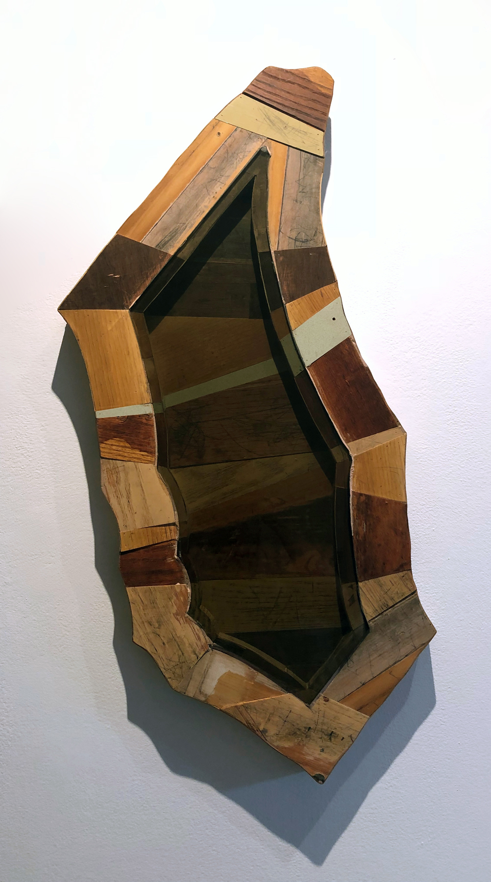Figure/Ground, 35 x 20 x 2 inches / 88.9 x 50.8 x 5.1 cm, tinted found glass shard framed with materials from closed Chicago public schools, 2017