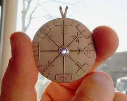 Viking compass with a functional cabochon of Iolite. Iolite was used for its polarizing effect, allowing ships to find the horizon through dense fog for navigation. Seen here in titanium.