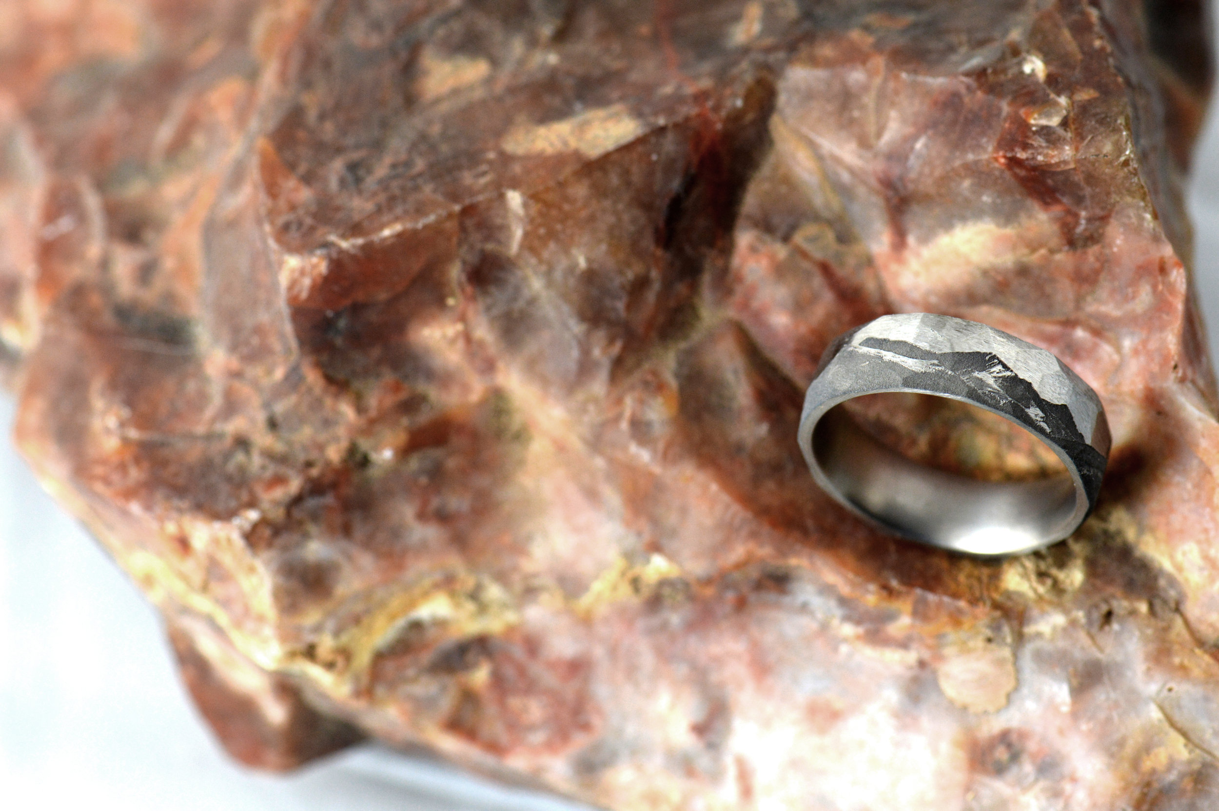 Facet finish on the titanium with a client provided image of a mountain range.