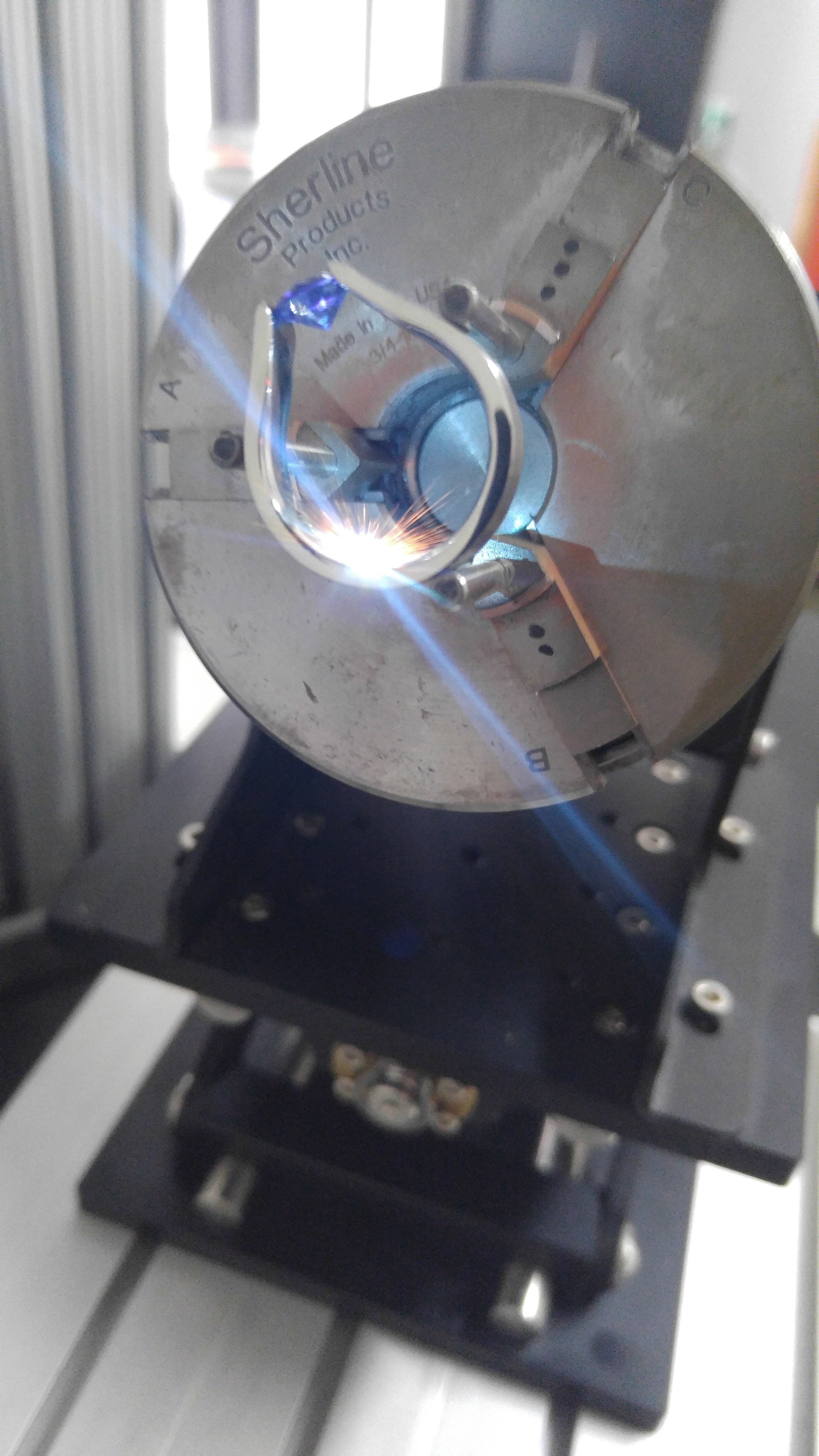 Engraving a tension set sapphire ring in action.