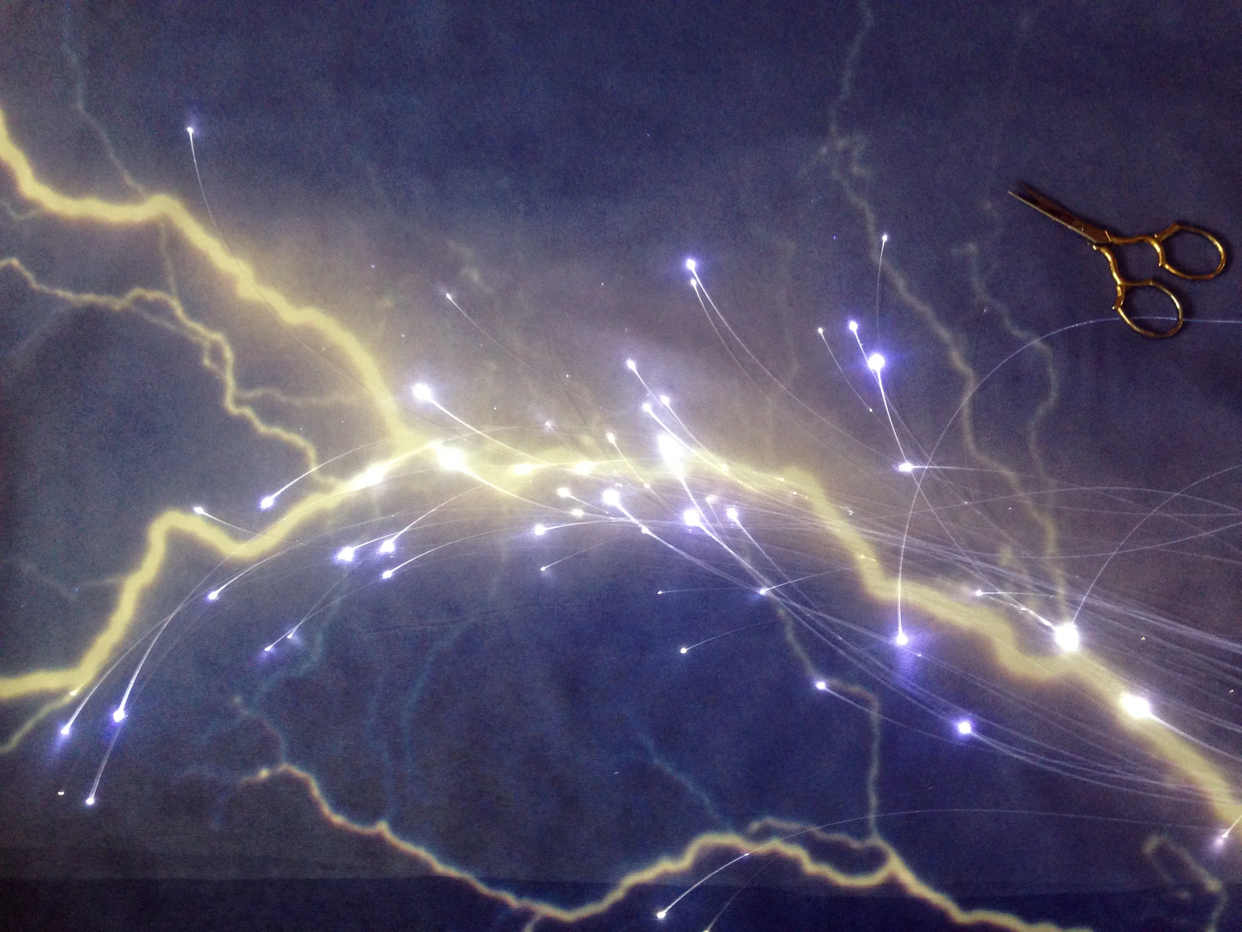 A fiber optic design is arranged under the surface textile to compliment the photographic image