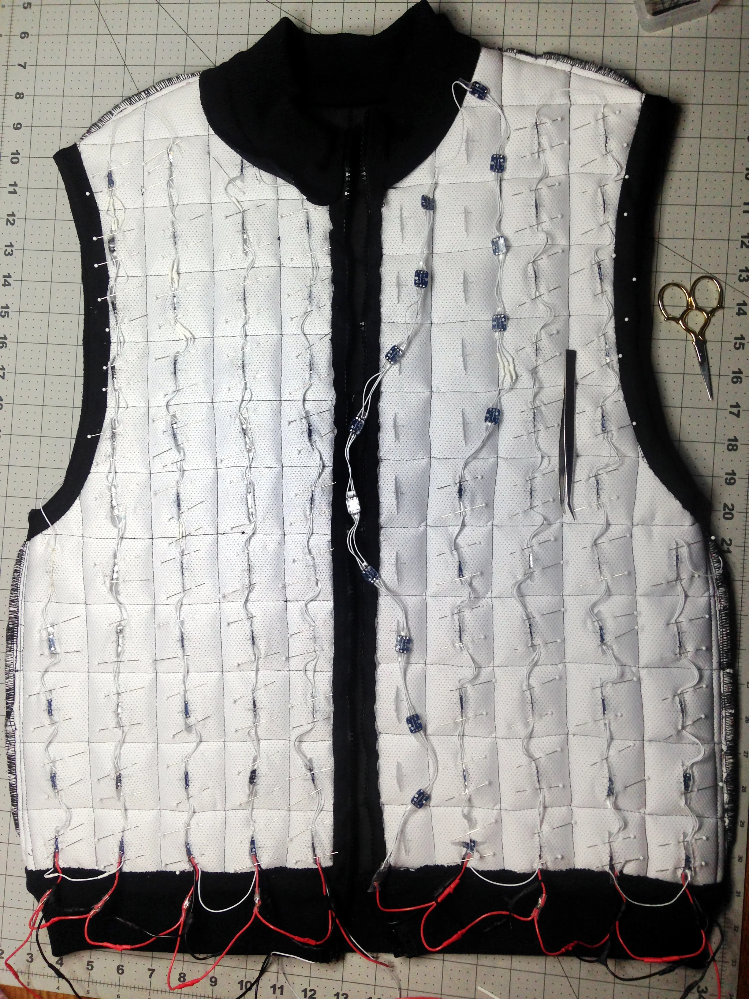 Wearlight under construction. Programmable LEDs are arranged to reflect across 2-inch pixels and shine through the outer textile layer. All electronics are hidden within the lining (not yet added in photo)