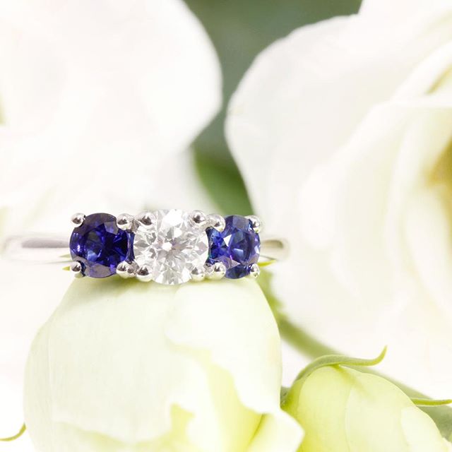 A trilogy engagement ring, exclusively designed for one of our most recent clients. Ceylon sapphires shouldering a brilliant cut diamond on a platinum shank. All our rings come with complimentary engraving and aftercare package, find out more at http