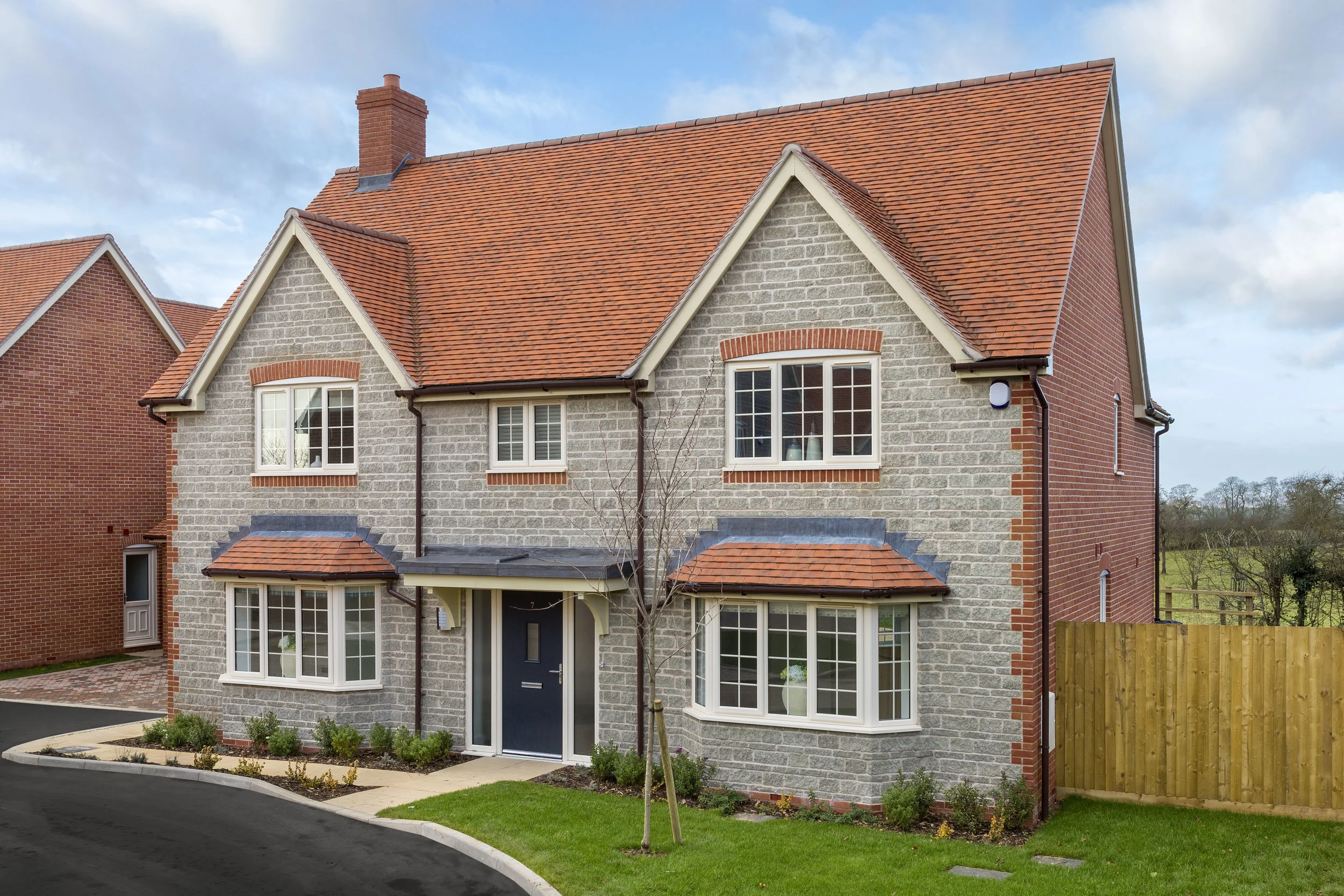 image of a completed home, showing brick complimenting stone with a rural backdrop
