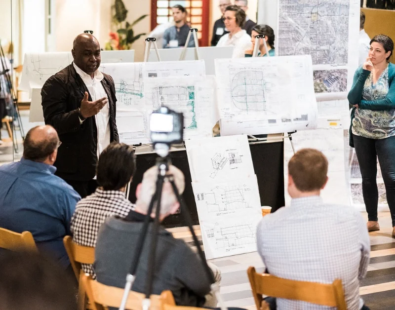 This is a group critique where the architects and planners share their initial ideas at a recent charrette for an existing urban development.