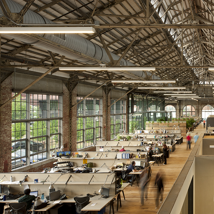 Each of URBN’s buildings were once military factories, which one can easily see to this day. They repurposed concrete, doors, steal beams, even cranes to create the decor inside massive brick structures with floor-to-ceiling windows.