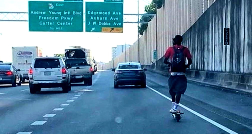 A man caught riding an e-scooter on the highway in Atlanta.