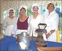 Historical Society Colonial Ladies describe a variety of artifacts. From left, Izzy Gilman, Linda Tetrault, Norma Rogers and Caroline Rowe.