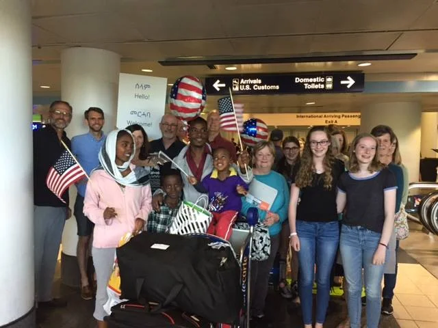 Greeting a new refugee family at the airport.