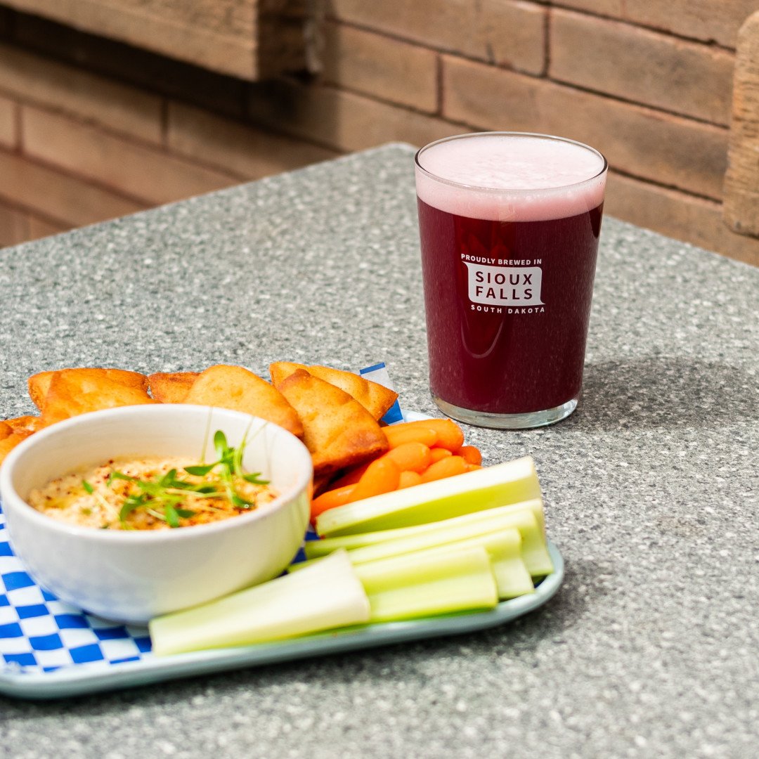 Looking for a refreshing summer snack? Look no further than the new hummus plate from @WagooBurger! House-made pita chips paired with crisp, fresh veggies provide a satisfying crunch. Complete your snack session with our Double Berry Curio, for a bal