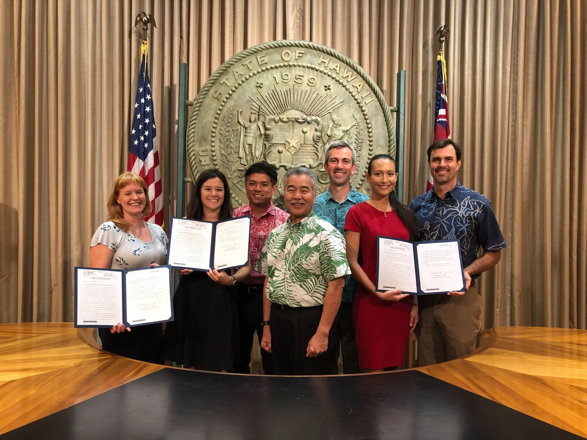 Jodi (pictured in red) joined Governor Ige and friends from Ulupono Initiative, Elemental Excelerator, and the Honolulu Office of Climate Change, Resiliency, and Sustainability for the 2019 environmental bills signing, where 7 bills were signed into law.